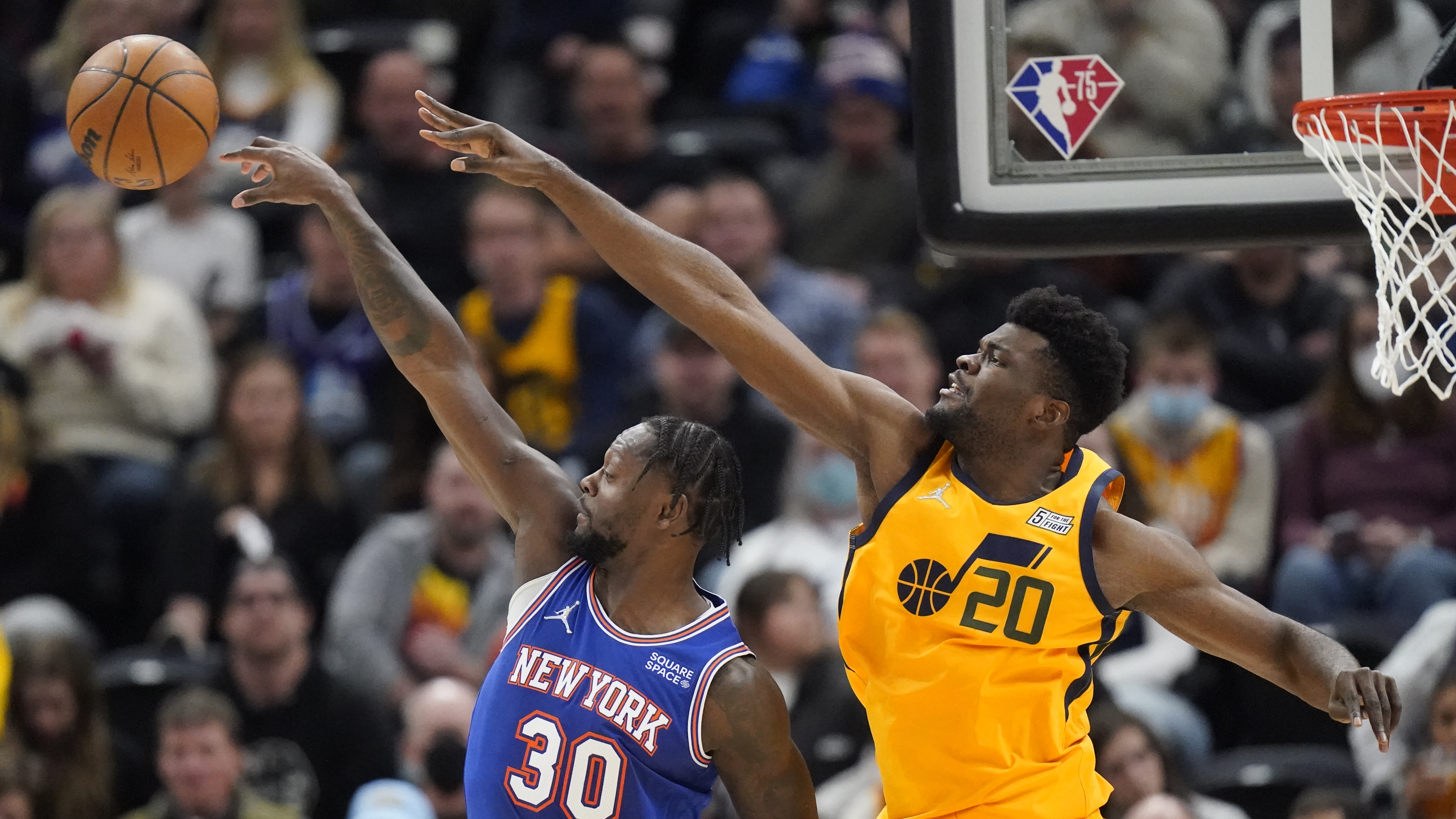 Utah Jazz center Udoka Azubuike (20) defends against New York Knicks forward Julius Randle (30) during the second half of an NBA basketball game Monday, Feb. 7, 2022, in Salt Lake City. 