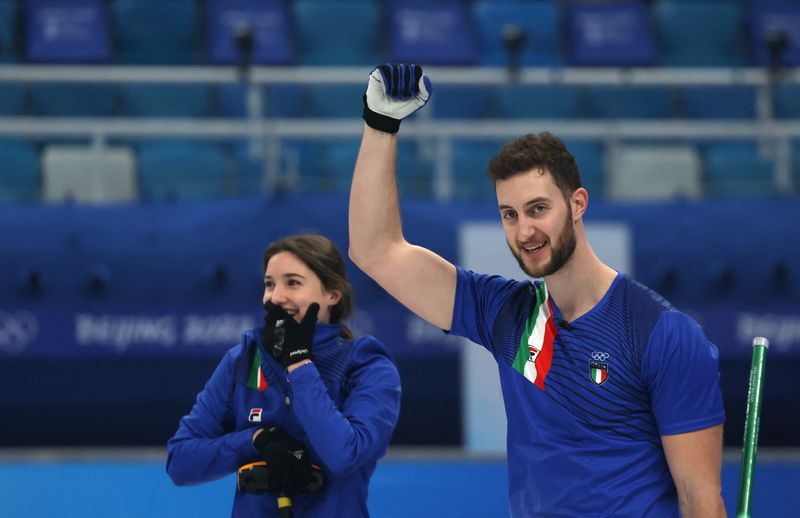 2022 Beijing Olympics - Curling - Mixed Doubles Gold Medal Game - Italy v Norway - National Aquatics Center, Beijing, China - February 8, 2022. Stefania Constantini of Italy and Amos Mosaner of Italy celebrate after winning the gold medal.
