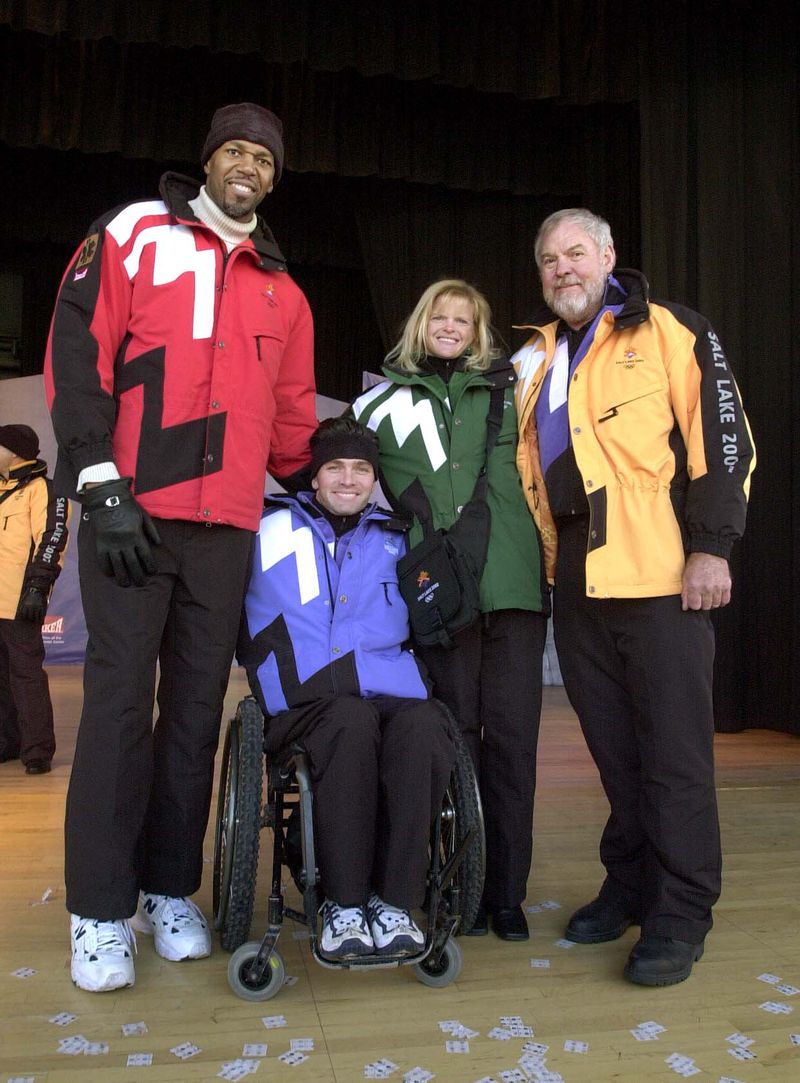 Former NBA player Thurl Bailey, left, Paralympian Chris
Waddell, Olympian Nikki Stone and the late actor Merlin Olsen model
in the Olympic volunteer and staff uniforms during an unveiling of
the Olympic uniforms during a press event in January
2000.