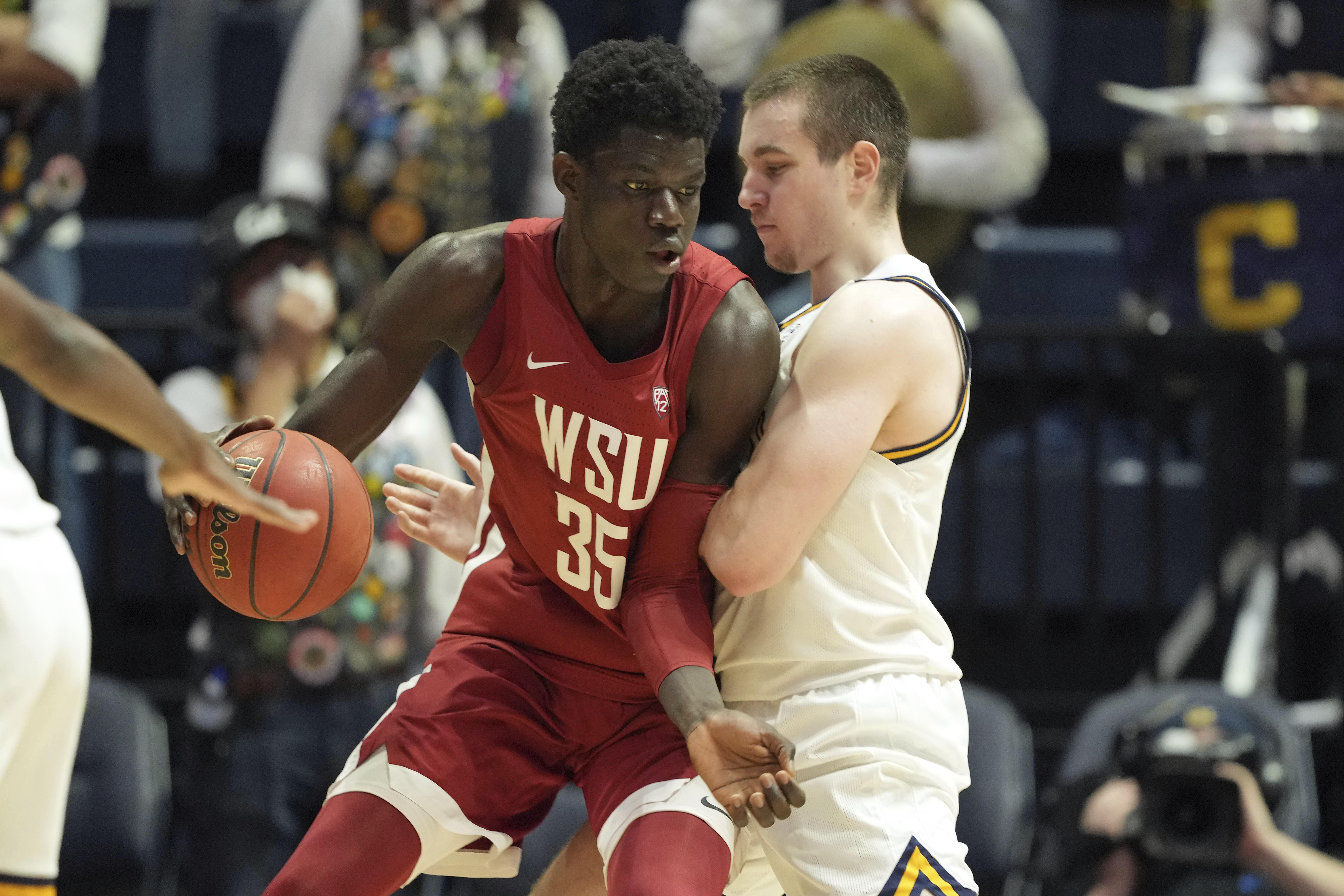 Washington State forward Mouhamed Gueye (35) dribbles while defended by California forward Grant Anticevich during the second half of an NCAA college basketball game in Berkeley, Calif., Saturday, Feb. 5, 2022. 