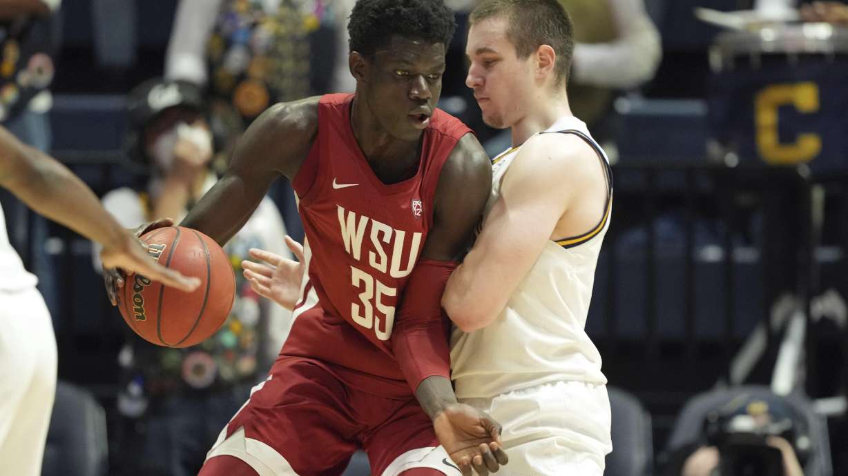 Washington State forward Mouhamed Gueye (35) dribbles while defended by California forward Grant Anticevich during the second half of an NCAA college basketball game in Berkeley, Calif., Saturday, Feb. 5, 2022.