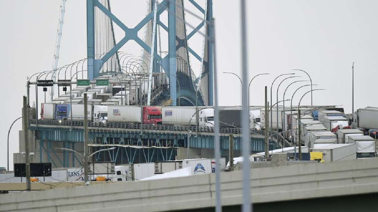 Trucks are backed up heading to and from Canada on the Ambassador Bridge, due to protests on the Windsor side, in Detroit on Monday.