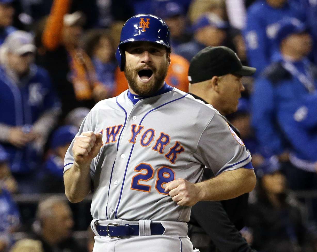 New York Mets' Daniel Murphy reacts as he scores from second on a hit by Lucas Duda during the fourth inning of Game 2 of baseball's World Series against the Kansas City Royals on, Oct. 28, 2015. Murphy originally returned from baseball in 2021.