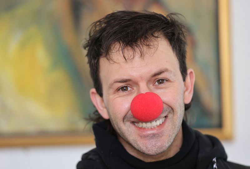 Jason Dickerson, a multimedia artist, wears a clown
nose and dresses the part while showing his Furniture 4 Clowns work
in Salt Lake City on Feb. 4.