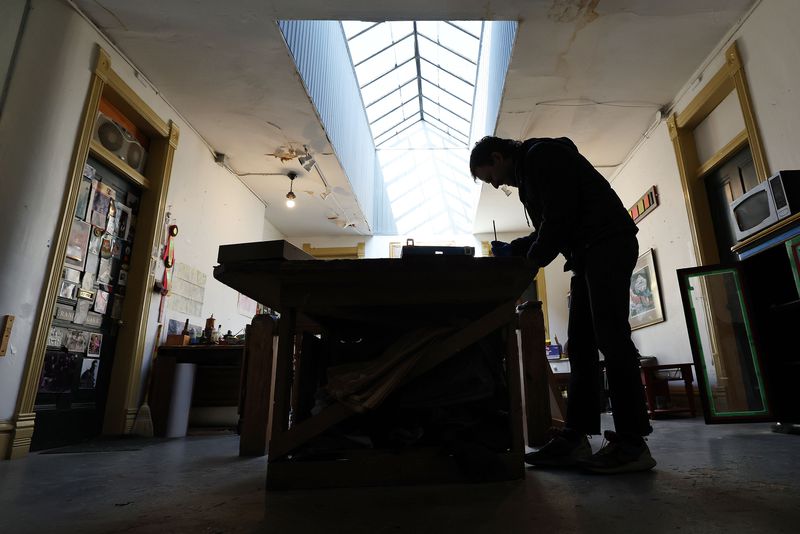 Jason Dickerson, a multimedia artist, works on his
Furniture 4 Clowns project at the historic Guthrie Building in Salt
Lake City on Feb. 4.