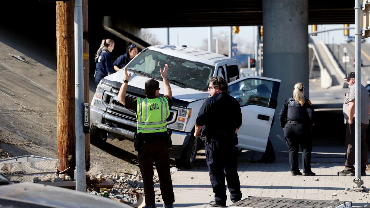 A forensics team collects evidence as it processes a crash scene at 1300 South and 400 West in Salt Lake City on Tuesday, following reports of a man assaulting a police officer then stealing a truck from a construction site and crashing at this location.