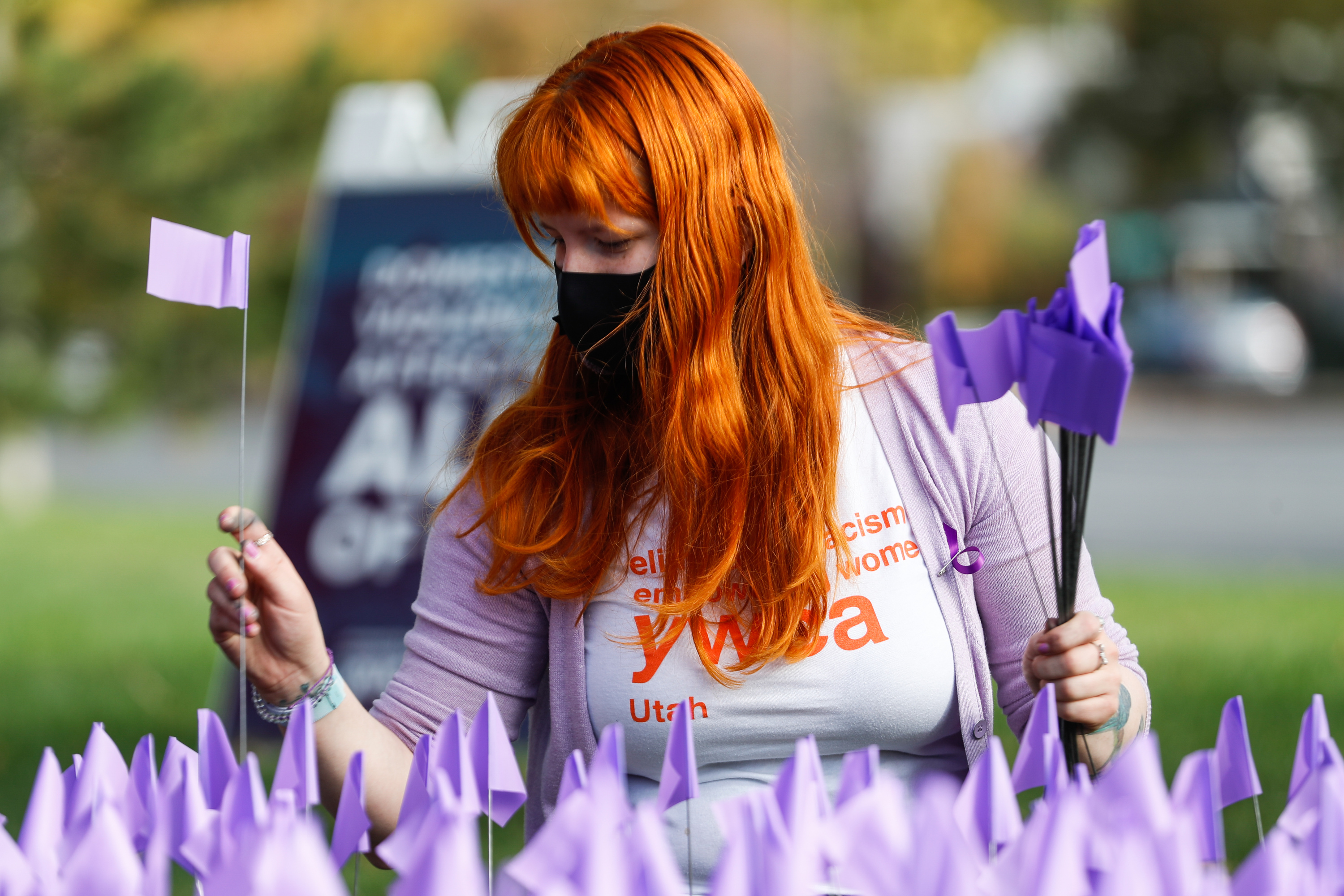 Christa Lynn Luckenbach plants a flag during a purple flag planting event at Liberty Park in Salt Lake City on Oct. 17, 2020. Domestic violence advocates met at the State Capitol on Tuesday to call for more funding and resources amid the increased need.