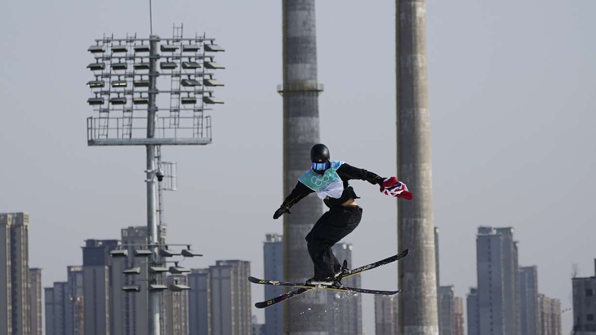 Gold medalist Birk Ruud of Norway holds his country's flag during the men's freestyle skiing big air finals of the 2022 Winter Olympics, Wednesday, Feb. 9, 2022, in Beijing.