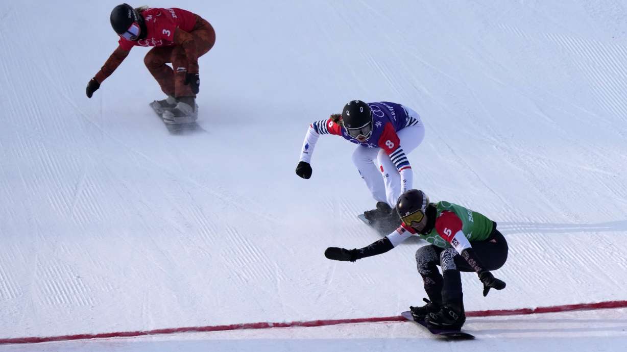 United States' Lindsey Jacobellis (5), followed by France's Chloe Trespeuch (8) and Canada's Meryeta O'Dine (3) crosses the finish line to win a gold medal during the women's cross final at the 2022 Winter Olympics, Wednesday, in Zhangjiakou, China.