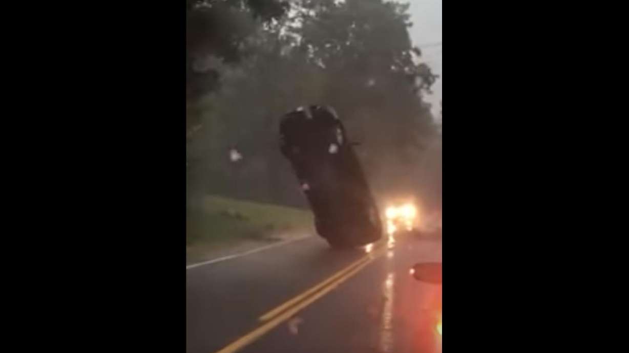 A car somehow got caught in power lines and appeared to be dangling in midair on Mountain Road in Suffield, Connecticut. (Video courtesy of Samantha Munn)