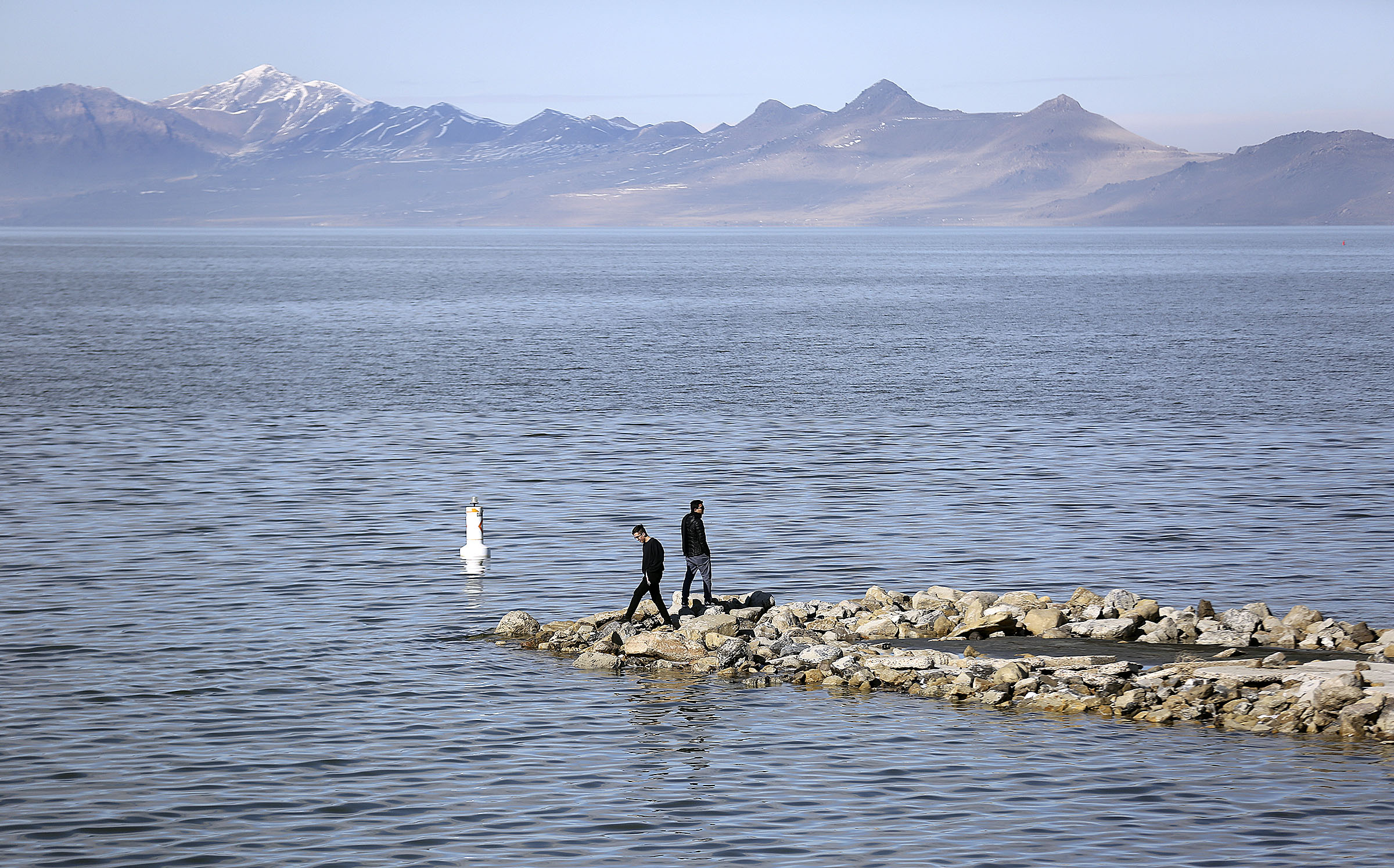 Lenny Liechty and Leonardo Arias explore the shore of the Great Salt Lake at Great Salt Lake State Park on Wednesday, Feb. 12, 2020.