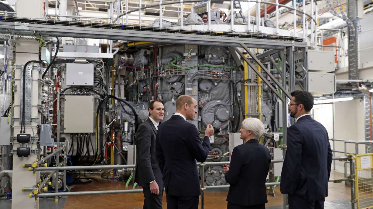 Britain's Prince William, Duke of Cambridge, second left, talks with Professor Ian Chapman, CEO of the UK Atomic Energy Authority, left, Nanna Heiberg, 2nd right, and Joseph Milnes, head of engineering design unit, right, alongside the MAST Upgrade chamber, in Abingdon, southern England, on Oct. 18, 2018. Researchers at the Joint European Torus experiment near Oxford managed to produce a record amount of heat energy over a five-second period, which was the duration of the experiment, the U.K. Atomic Energy Authority announced on Wednesday, Feb. 9, 2022.