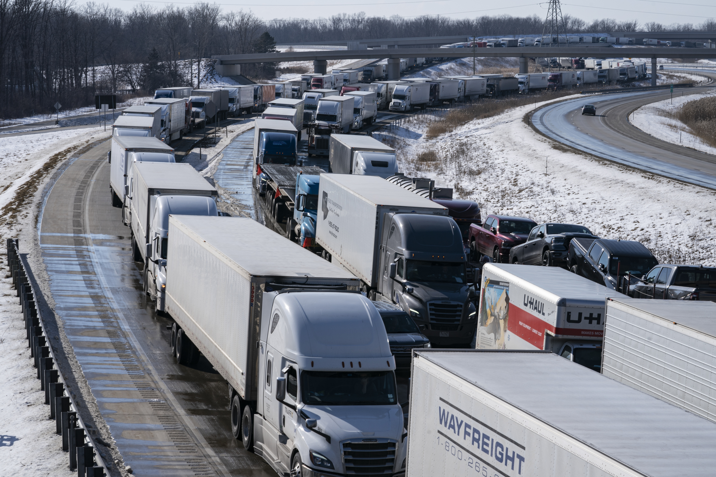 Trucks heading to Canada are stuck in heavy traffic after they were diverted to the Blue Water Bridge in Port Huron, Mich., Wednesday, after the Ambassador Bridge was closed due to Canadian anti-vaccine protests.