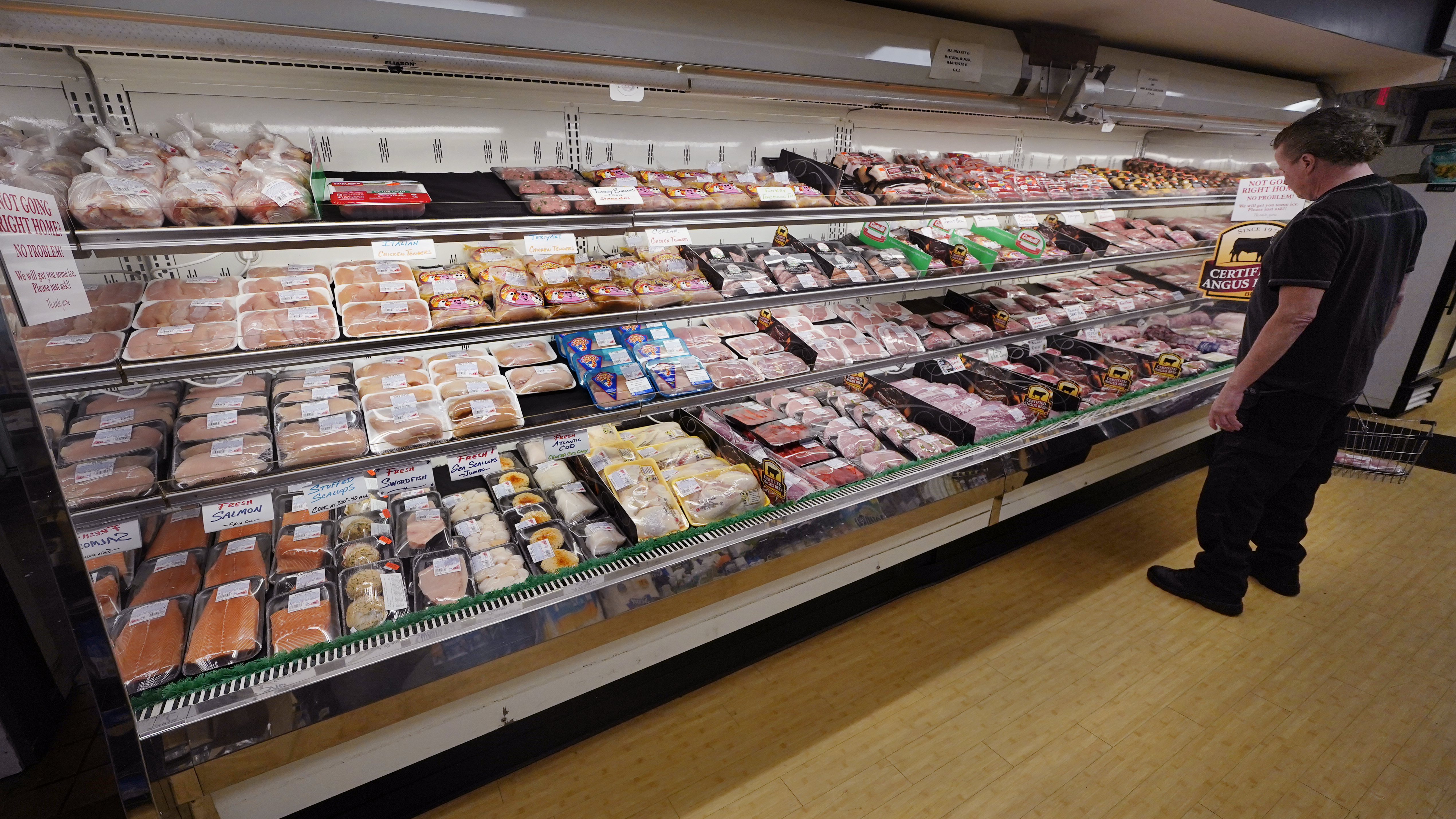 A man looks at beef in the meat department at Lambert's Rainbow Market, on June 15, 2021 in Westwood, Mass.  The Labor Department said Thursday that consumer prices jumped 7.5% last month compared with a year earlier, the steepest year-over-year increase since February 1982.