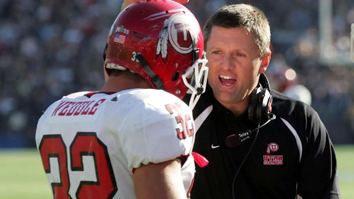 University of Utah football coach Kyle Whittingham congratulates Eric Weddle after a game against BYU in Provo on Nov. 19, 2005. Weddle will be making his first Super Bowl appearance on Sunday.