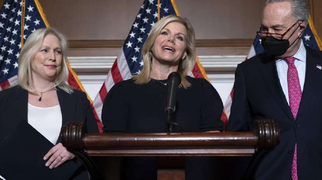Former Fox News anchor Gretchen Carlson, center, celebrates with Sen. Kirsten Gillibrand, D-N.Y., left, and Senate Majority Leader Chuck Schumer, D-N.Y., at the Capitol in Washington, Thursday, after Congress gave final approval to legislation guaranteeing that people who experience sexual harassment at work can seek recourse in the courts.