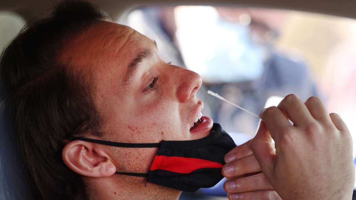 Von Satter swabs his nose for a COVID-19 test at the University of Utah in Salt Lake City on Jan. 31. The Utah Department of Health reported 1,935 COVID-19 cases and 13 deaths on Thursday.