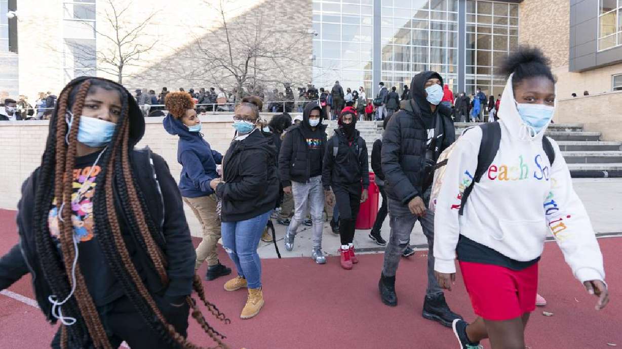 People leave Dunbar High School in Washington on Tuesday, after Doug Emhoff, the husband of Vice President Kamala Harris, was whisked out of a Black History Month commemoration event at the high school by Secret Service agents following an apparent bomb threat. Thursday a 16-year-old was charged with calling bomb threats.