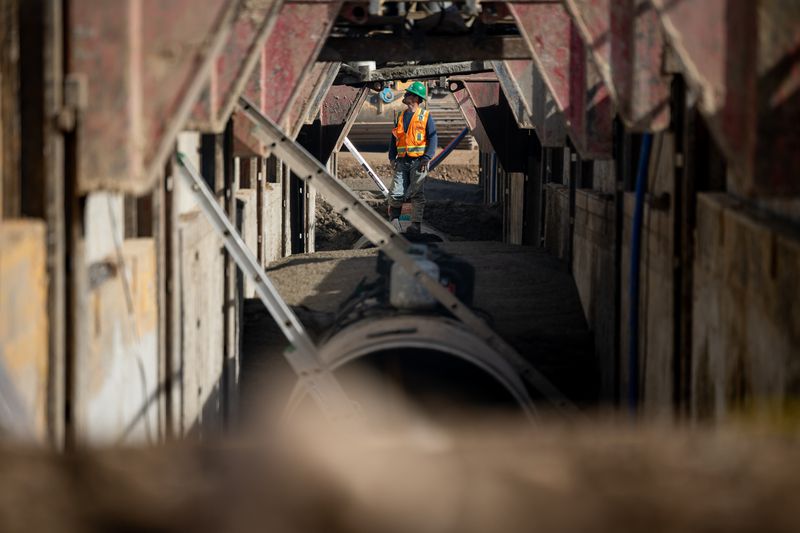 A worker stands atop a section of 60-inch welded steel
pipe that is part of the Spanish Fork Canyon – Santaquin Pipeline,
a part of the Central Utah Project, in Spanish Fork on Thursday.