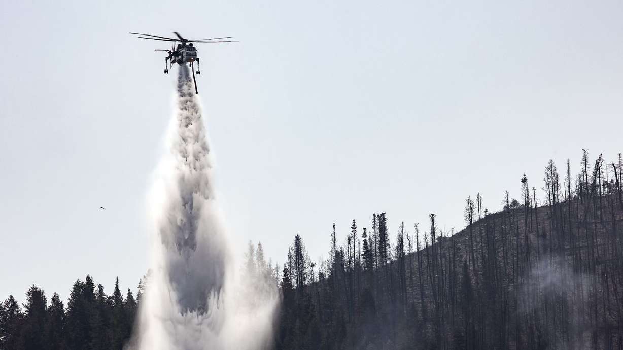 A helicopter drops water on hot spots as crews fight the Parleys Canyon Fire near Park City on Aug. 16, 2021. Utah lawmakers are pushing for a study on the "preference” of water rights, or who should get how much if the state declares an emergency of a temporary water supply shortage.