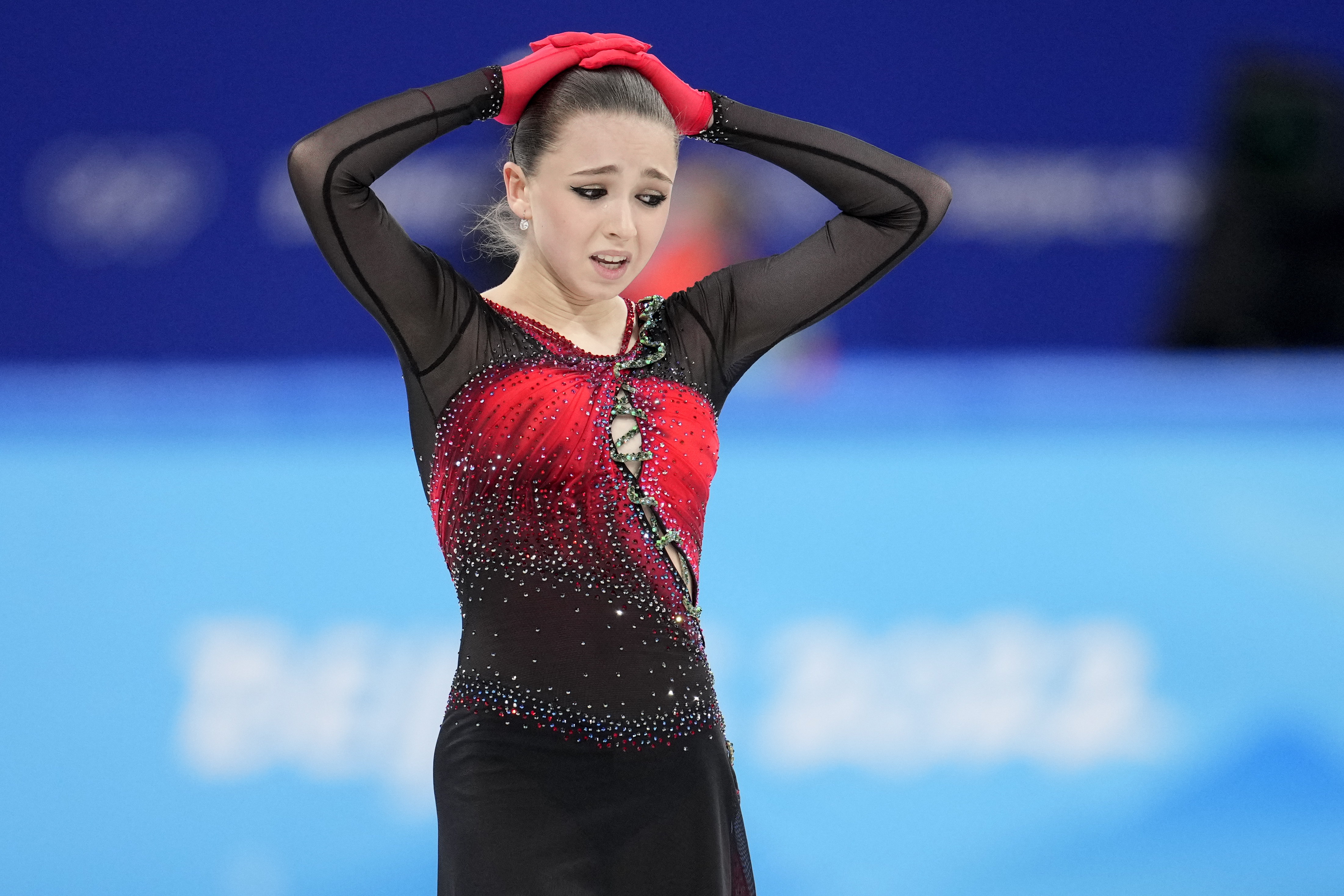 Kamila Valieva, 15, of the Russian Olympic Committee, reacts after the women's team free skate program during the figure skating competition at the 2022 Winter Olympics, Monday, Feb. 7, 2022, in Beijing. Valieva is at the center of the biggest doping story of the Beijing Games after the Russian newspaper RBC reported that the figure skater tested positive for a banned heart medication before the Olympics. Valieva is a “protected person” according to the World Anti-Doping Code, which includes athletes who have not yet turned 16 at the time of a doping violation. 