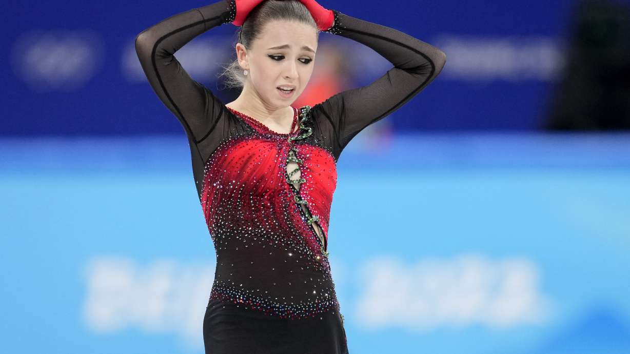 Kamila Valieva, 15, of the Russian Olympic Committee, reacts after the women's team free skate program during the figure skating competition at the 2022 Winter Olympics, Monday, Feb. 7, 2022, in Beijing. Valieva is at the center of the biggest doping story of the Beijing Games after the Russian newspaper RBC reported that the figure skater tested positive for a banned heart medication before the Olympics. Valieva is a “protected person” according to the World Anti-Doping Code, which includes athletes who have not yet turned 16 at the time of a doping violation.