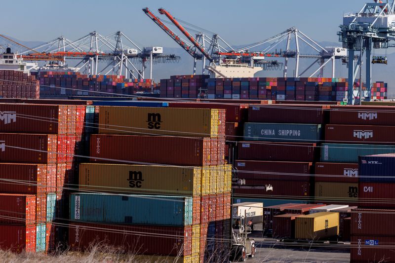 Stacked containers are shown as ships unload their cargo at the Port of Los Angeles in Los Angeles, Calif., Nov. 22, 2021.