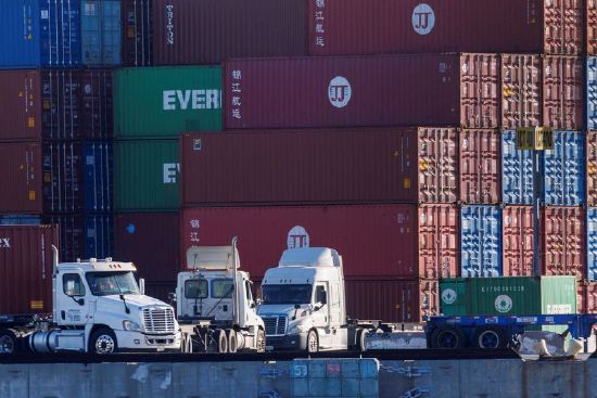 Trucks arrive to pick up containers at the Port of Los Angeles in Los Angeles, California, Nov. 22, 2021.