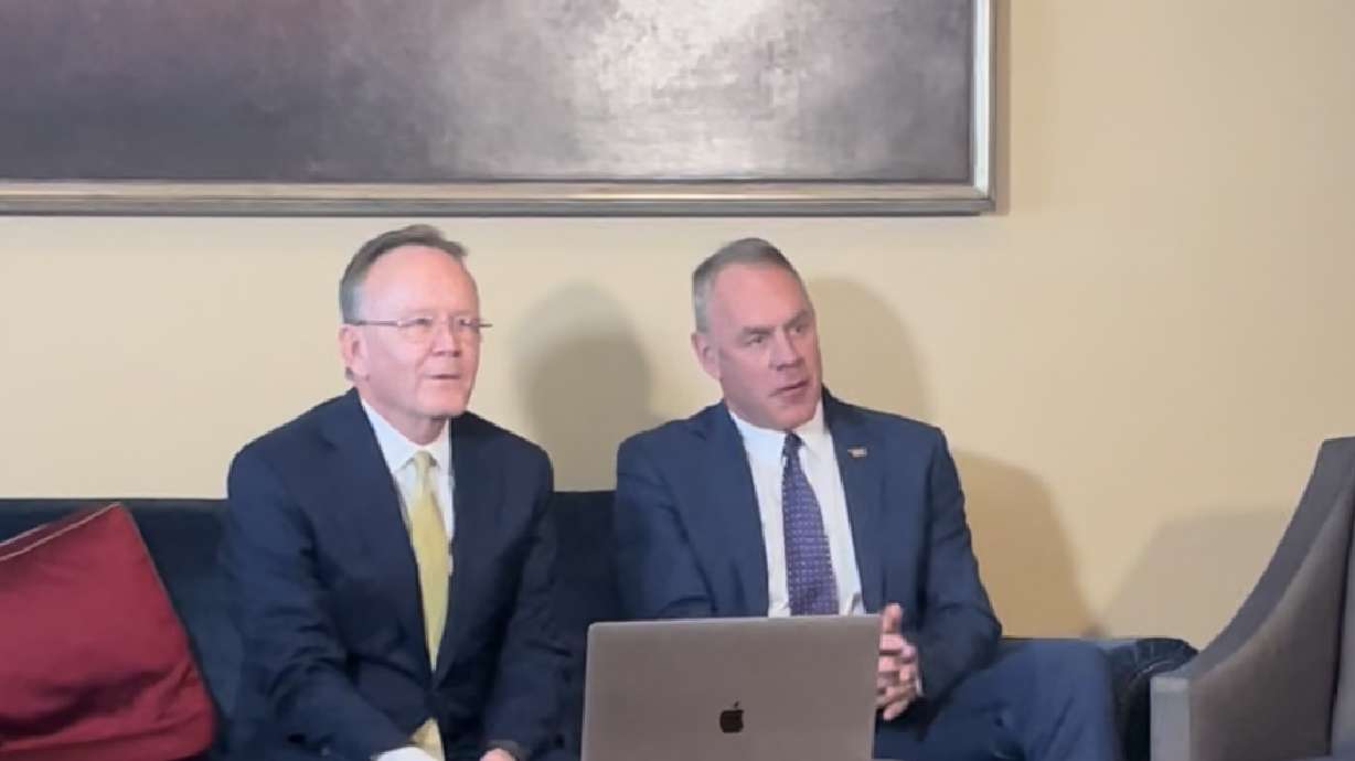 Utah Senate President Stuart Adams, left, speaks with reporters with former U.S. Secretary of the Interior Ryan Zinke on Friday in the state Capitol in Salt Lake City.