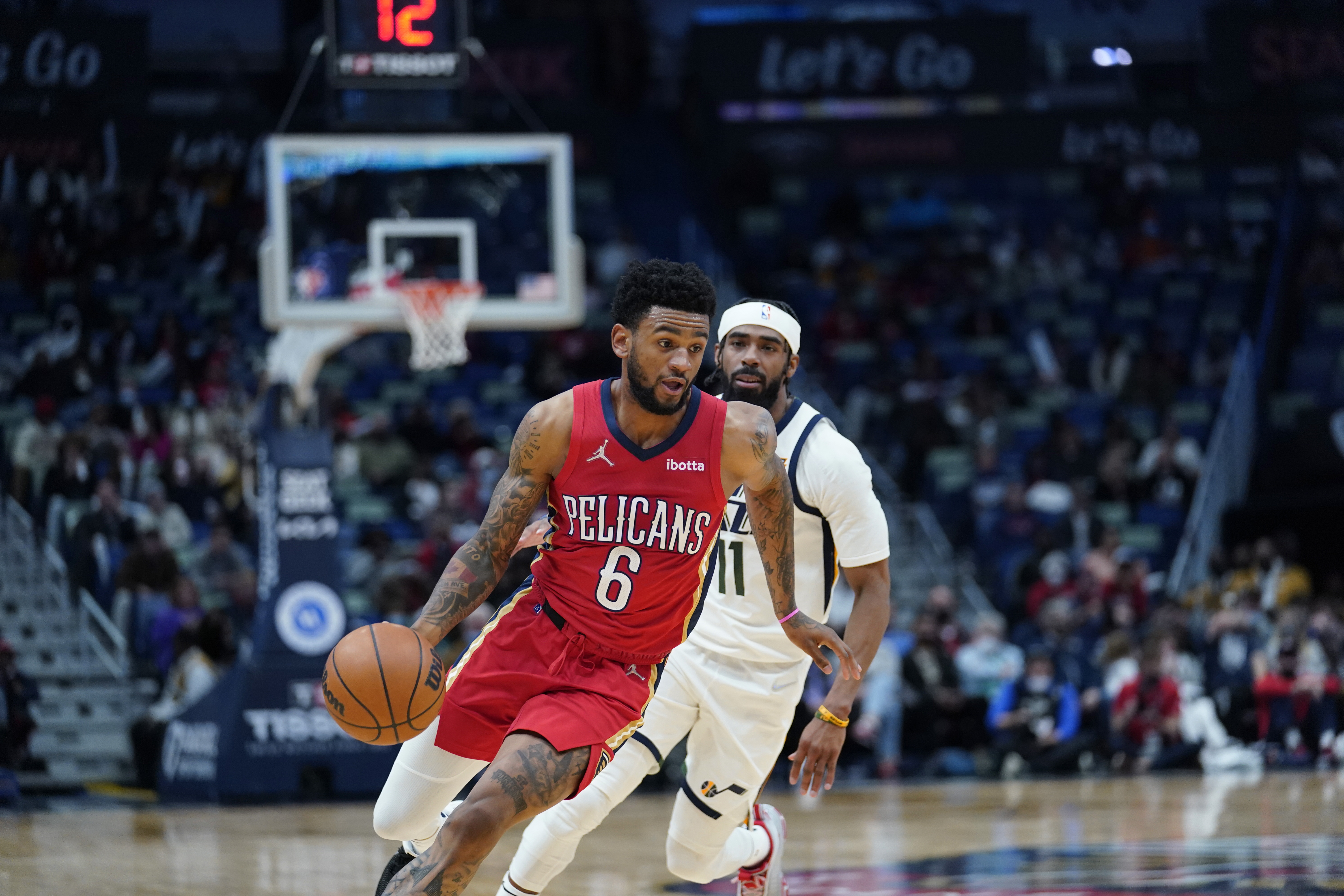 Nickeil Alexander-Walker (6) drives to the basket ahead of Utah Jazz guard Mike Conley (11) in the first half of an NBA basketball game in New Orleans, Monday, Jan. 3, 2022. Alexander-Walker was traded to the Jazz on Wednesday. 