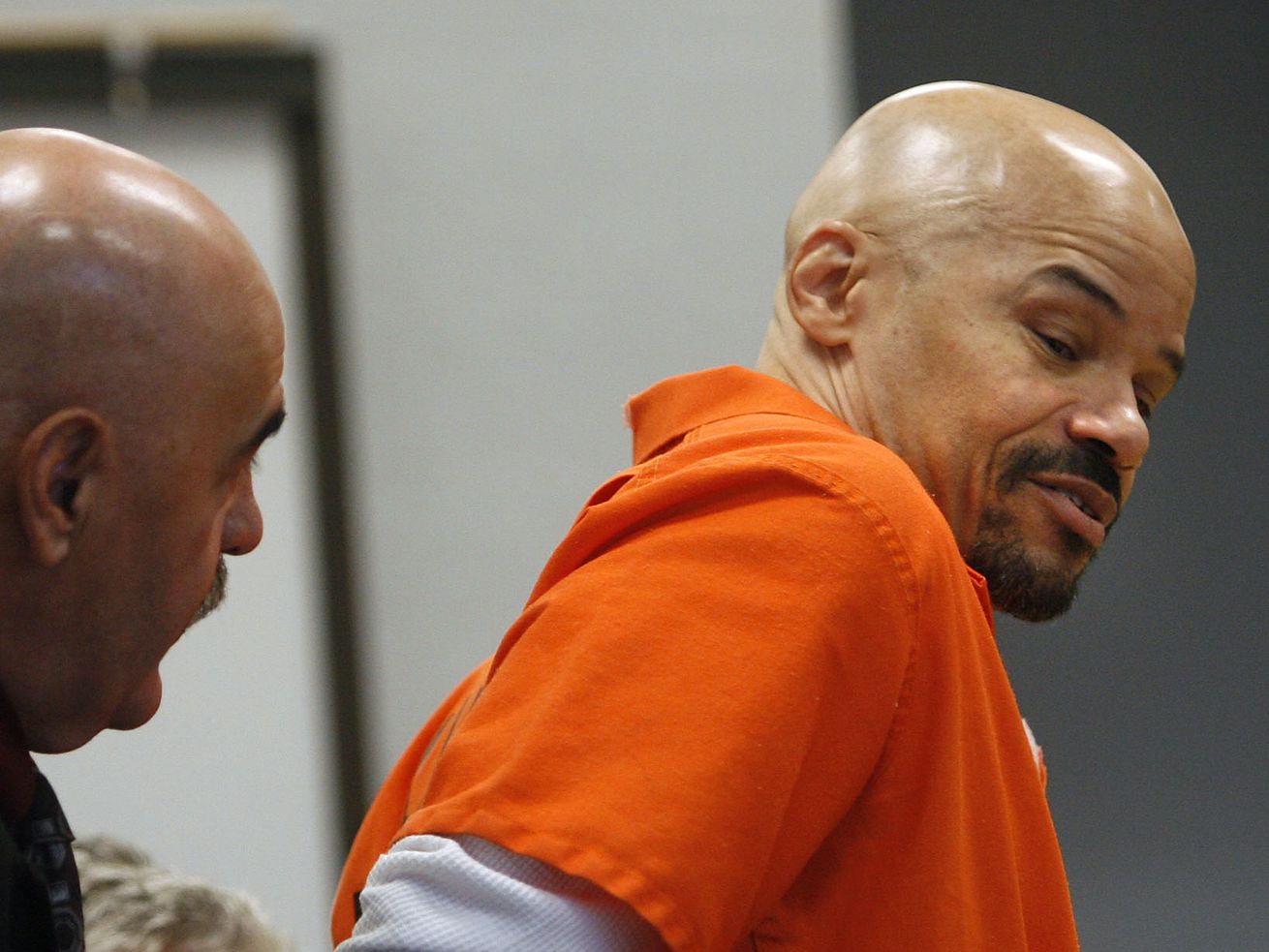 Douglas Stewart Carter, who has been on death row since 1985, has his shackles removed so he can take notes at the defense table during a hearing in Provo’s 4th District Court on Oct. 2,
2007.