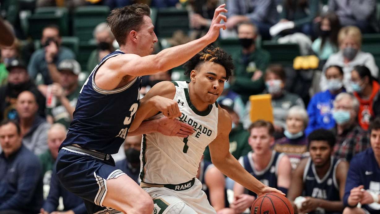Colorado State guard John Tonje (1) drives to the basket against Utah State forward Justin Bean (34) during the first half of an NCAA college basketball game Wednesday, Jan. 12, 2022, in Fort Collins, Colo.