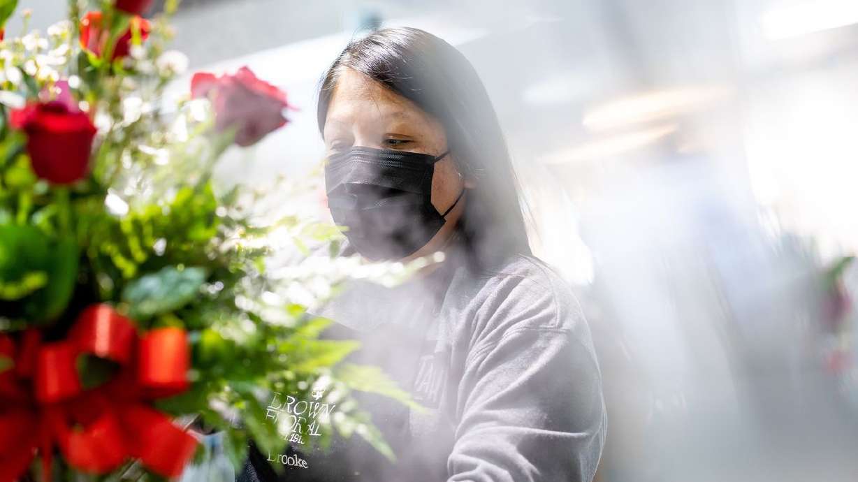 Floral designer Rhiannon Johnson works on a flower
arrangement at Brown Floral in Holladay on Tuesday.