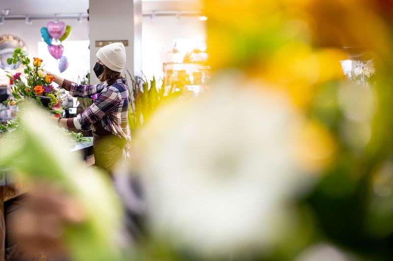 Floral designer Abbie Drage works on a flower
arrangement at Brown Floral in Holladay on Tuesday.