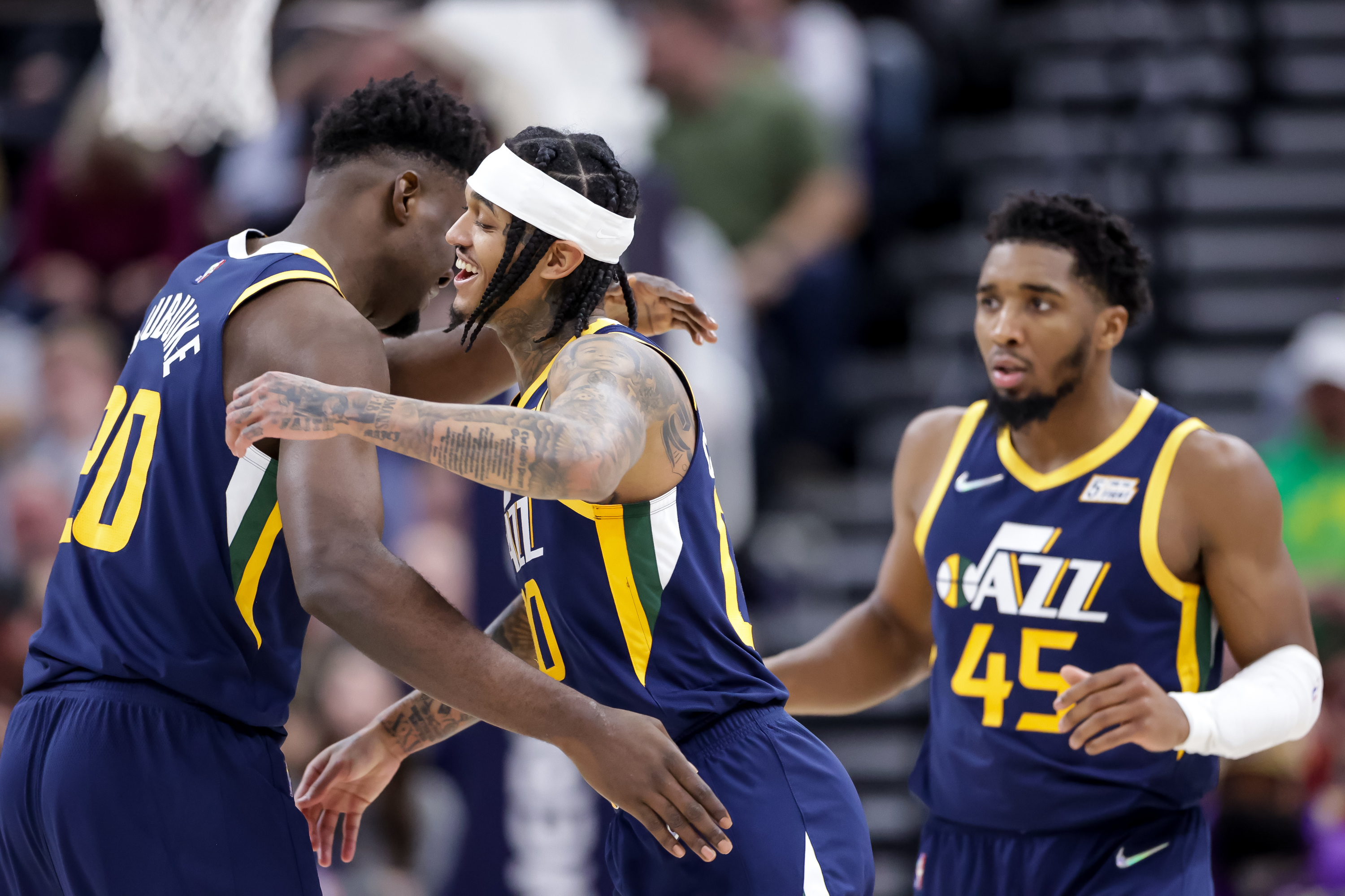 Utah Jazz center Udoka Azubuike (20) and guard Jordan Clarkson (00) hug after Azubuike slammed home a big dunk during the game against the Orlando Magic at Vivint Arena in Salt Lake City on Friday, Feb. 11, 2022.
