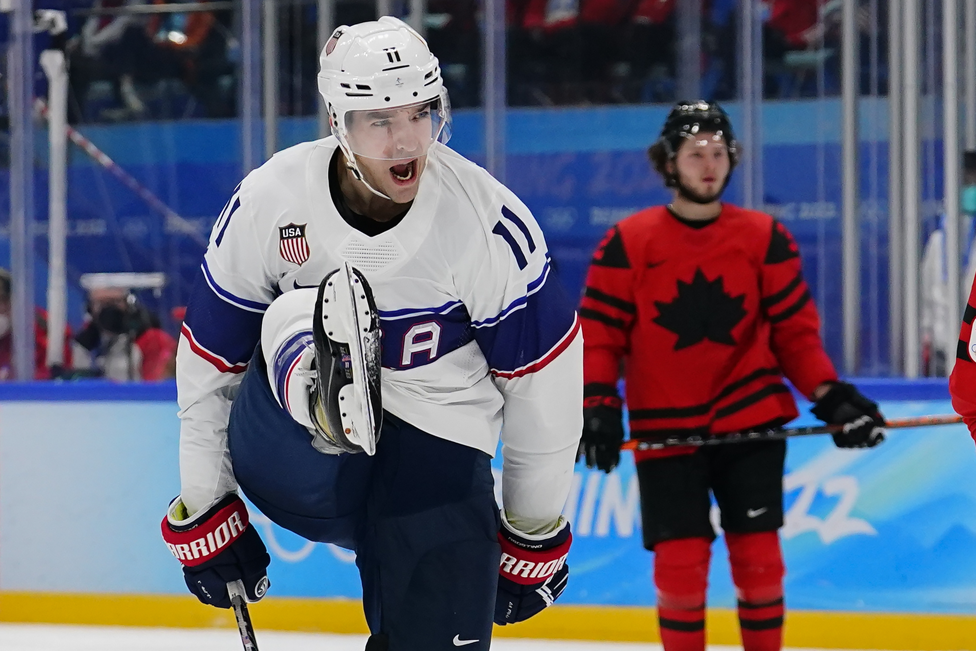 United States' Kenny Agostino (11) celebrates after scoring a goal against Canada during a preliminary round men's hockey game at the 2022 Winter Olympics, Saturday, Feb. 12, 2022, in Beijing. 