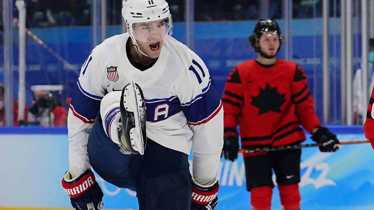 United States' Kenny Agostino (11) celebrates after scoring a goal against Canada during a preliminary round men's hockey game at the 2022 Winter Olympics, Saturday, Feb. 12, 2022, in Beijing.