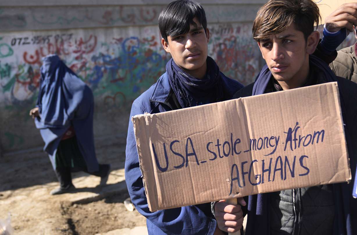 Afghan protesters hold placards and shout slogans against U.S. during a protest condemning President Joe Biden's decision, in Kabul, Afghanistan, Saturday. President Biden signed an executive order, Friday, to create a pathway to split $7 billion in Afghan assets frozen in the U.S. to fund humanitarian relief in Afghanistan and to create a trust fund to compensate Sept. 11 victims.
