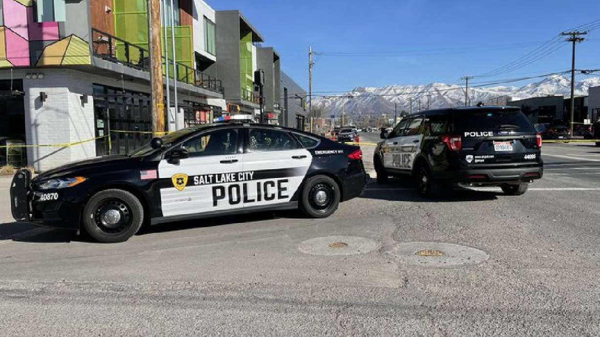 Police surround an area near 900 South and 100 West in Salt Lake City on Saturday, as they try to contact an individual barricaded in a vehicle.