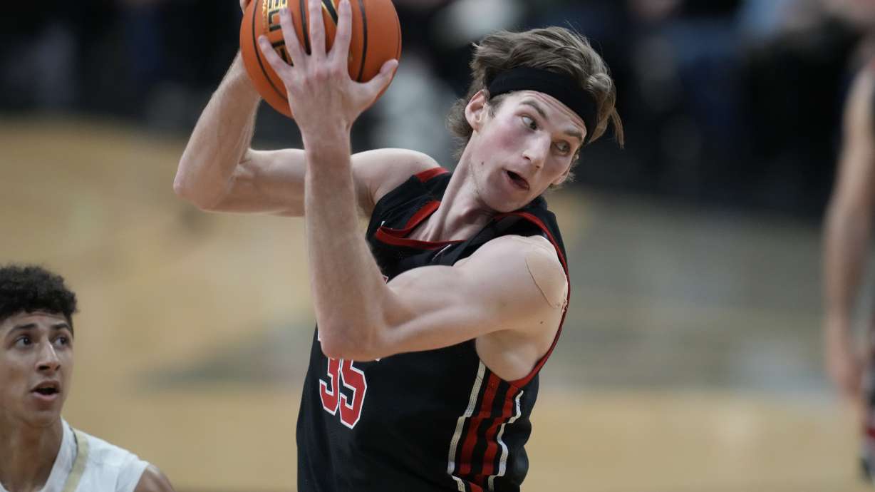 Utah center Branden Carlson, right, pulls in a rebound as Colorado guard Nique Clifford defends in the first half of an NCAA college basketball game Saturday, Feb. 12, 2022, in Boulder, Colo.
