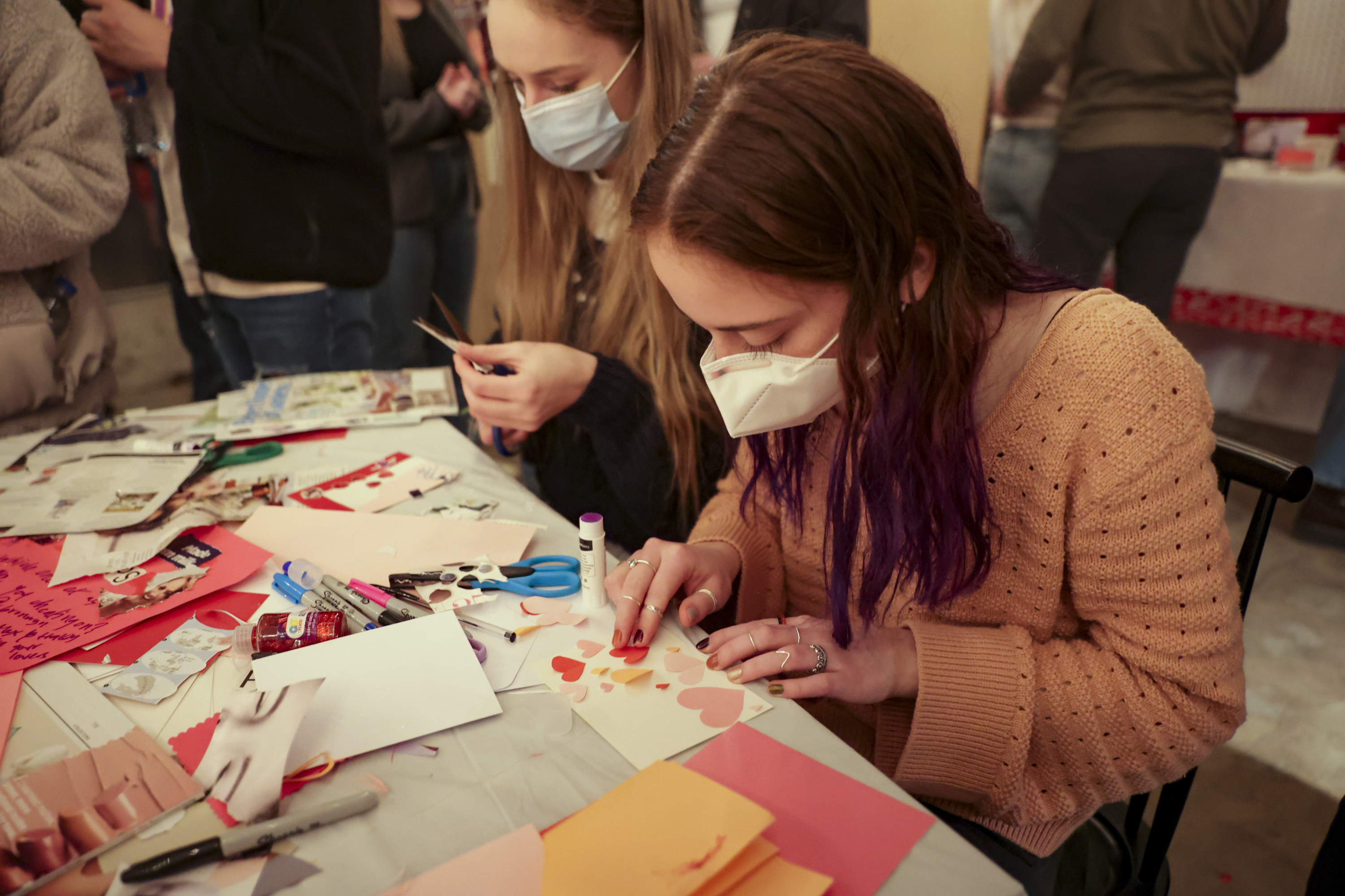 Anna May makes a card at the Valentine’s Pop-up Museum in Provo on Saturday. The museum's creator is hoping to challenge traditional ideas about Valentine's Day and rebrand the holiday to one that focuses on love, but not romance.
