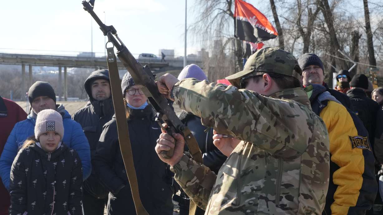 An instructor shows a Kalashnikov assault rifle as members of a Ukrainian far-right group train, in Kyiv, Ukraine, Sunday. Russia denies it intends to invade but has massed well over 100,000 troops near the Ukrainian border and has sent troops to exercises in neighboring Belarus, encircling Ukraine on three sides. U.S. officials say Russia's buildup of firepower has reached the point where it could invade on short notice.