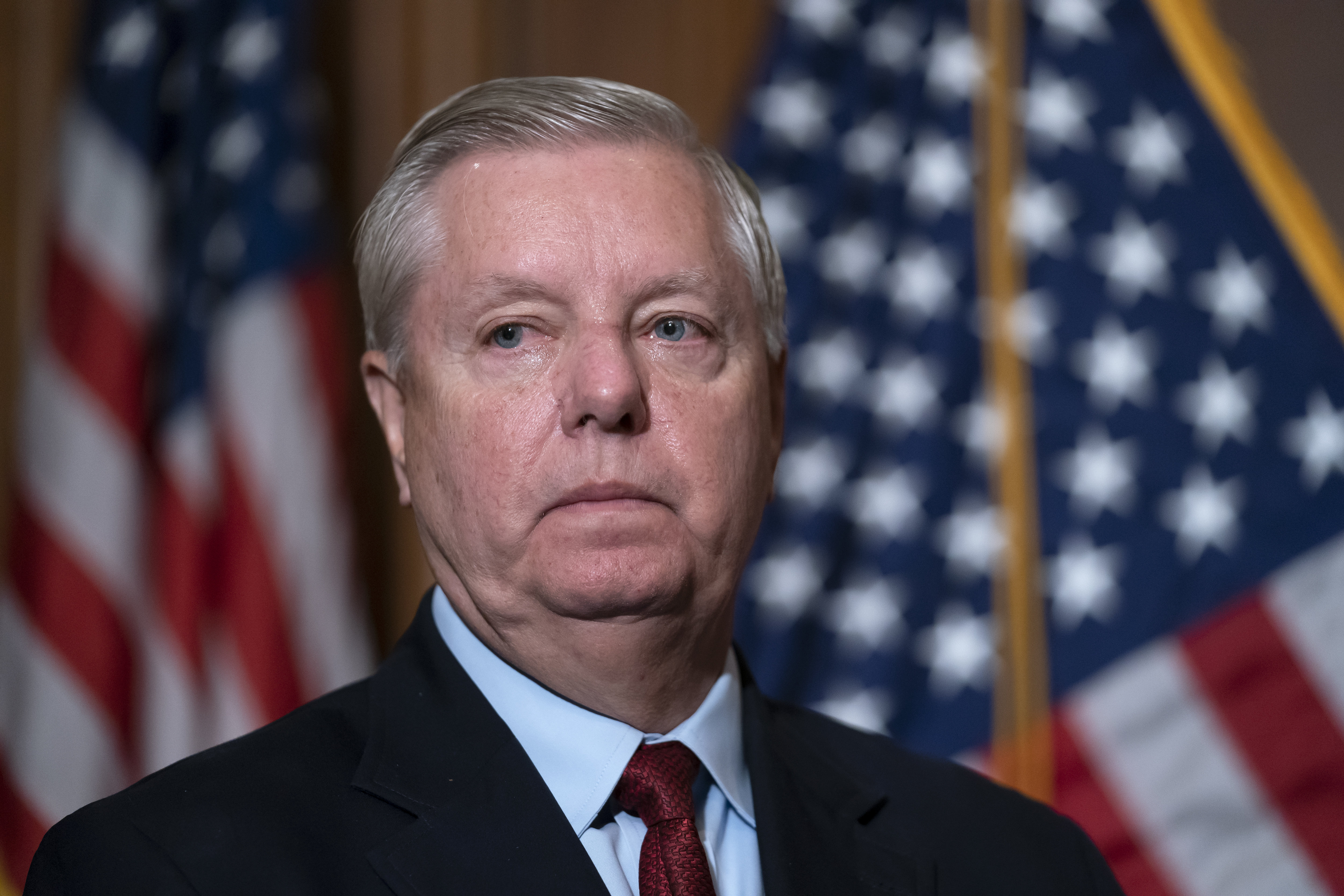 Sen. Lindsey Graham, R-S.C., the ranking member of the Senate Budget Committee, waits to speak to reporters at the Capitol in Washington on Thursday. Graham is among a handful of Republicans declaring their willingness to break party lines and vote for the yet-to-be-announced White House choice to replace retiring Justice Stephen Breyer.