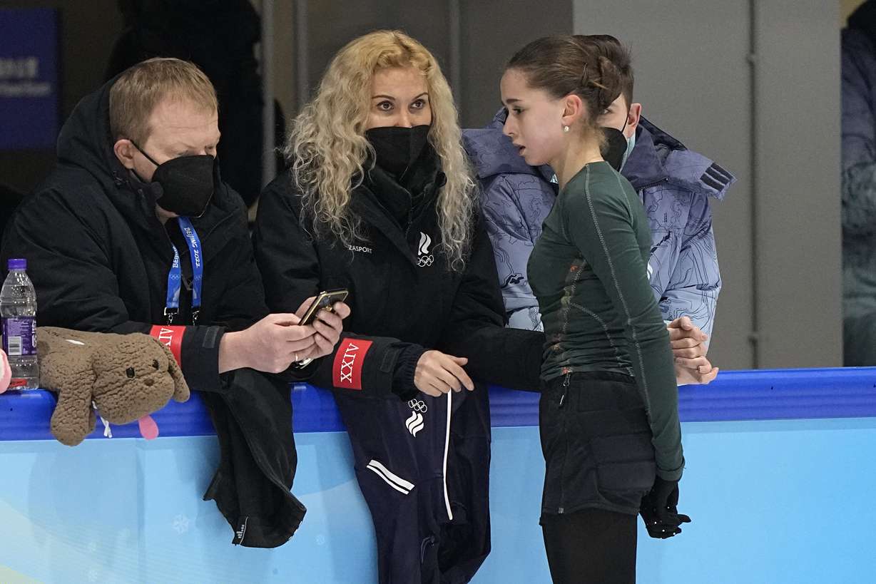 Coach Eteri Tutberidze, center, talks to Kamila Valieva, during a training session at the 2022 Winter Olympics, Sunday in Beijing.