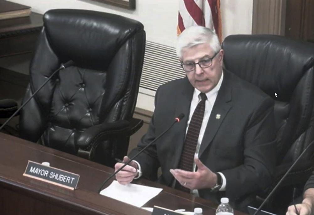 This image from a video shows Hudson, Ohio Mayor Craig Shubert in a city council meeting, Feb. 8, 2022 in Hudson, Ohio. Shubert, who had suggested allowing ice fishing shanties on a lake could lead to prostitution, has resigned. Shubert said he was stepping down Monday.