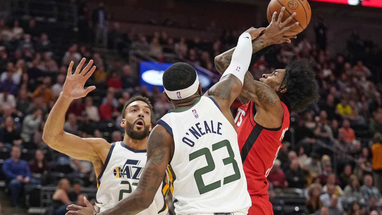 Houston Rockets guard Kevin Porter Jr., right, is fouled by Utah Jazz forward Royce O'Neale (23) as he goes to the basket during the first half of an NBA basketball game Monday, Feb. 14, 2022, in Salt Lake City.