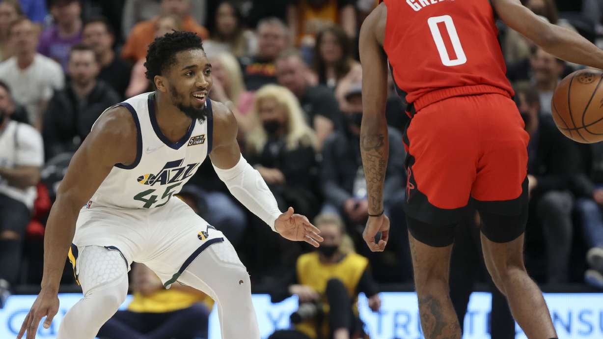 Utah Jazz guard Donovan Mitchell (45) smiles while guarding Houston Rockets guard Jalen Green (0) during an NBA game at the Vivint Arena in Salt Lake City on Monday.