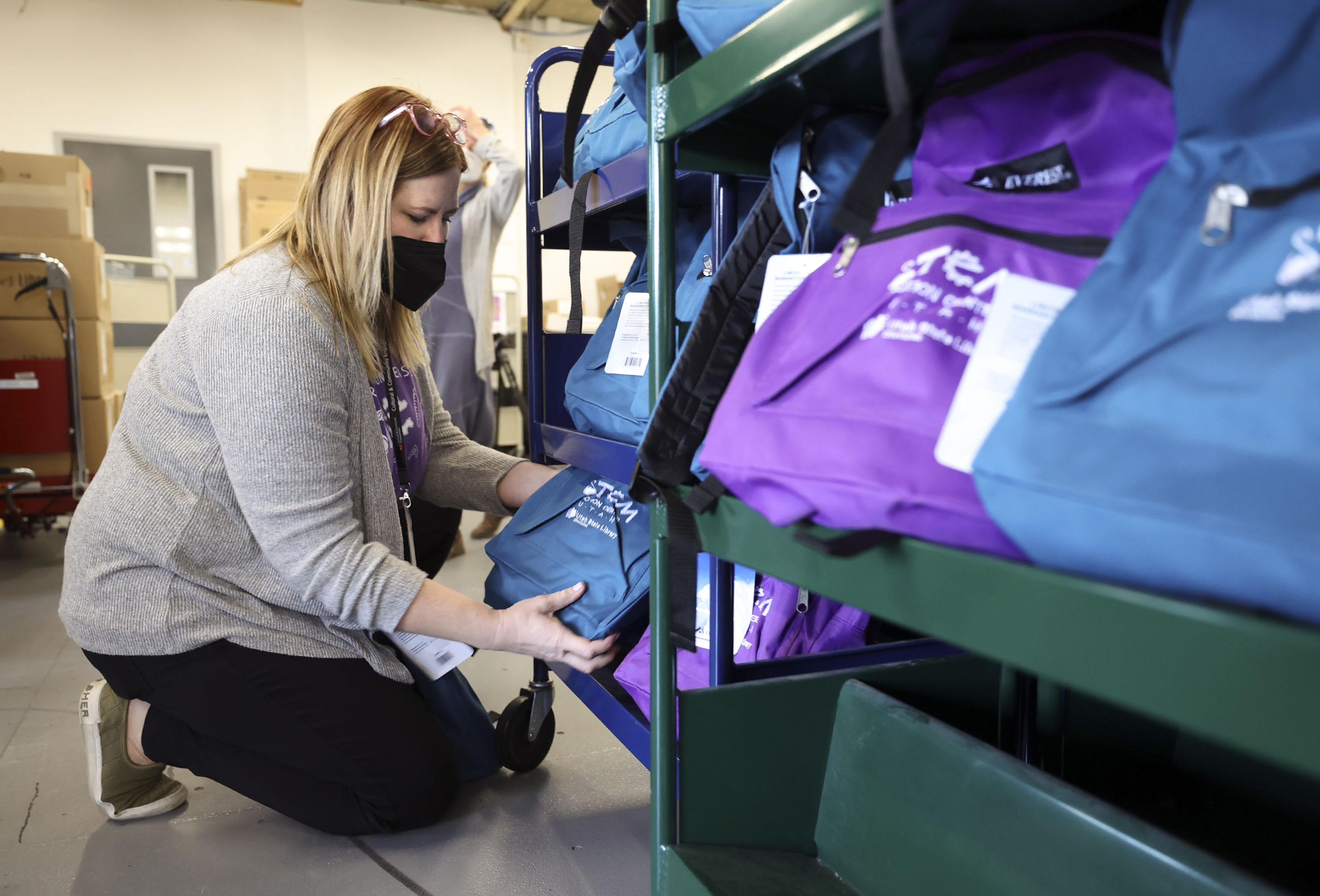 Shelby Averett, STEM Action Center communications manager, sets up the Science of Stress Relief backpacks for a press event at the Whitmore Library in Cottonwood Heights on Tuesday. 