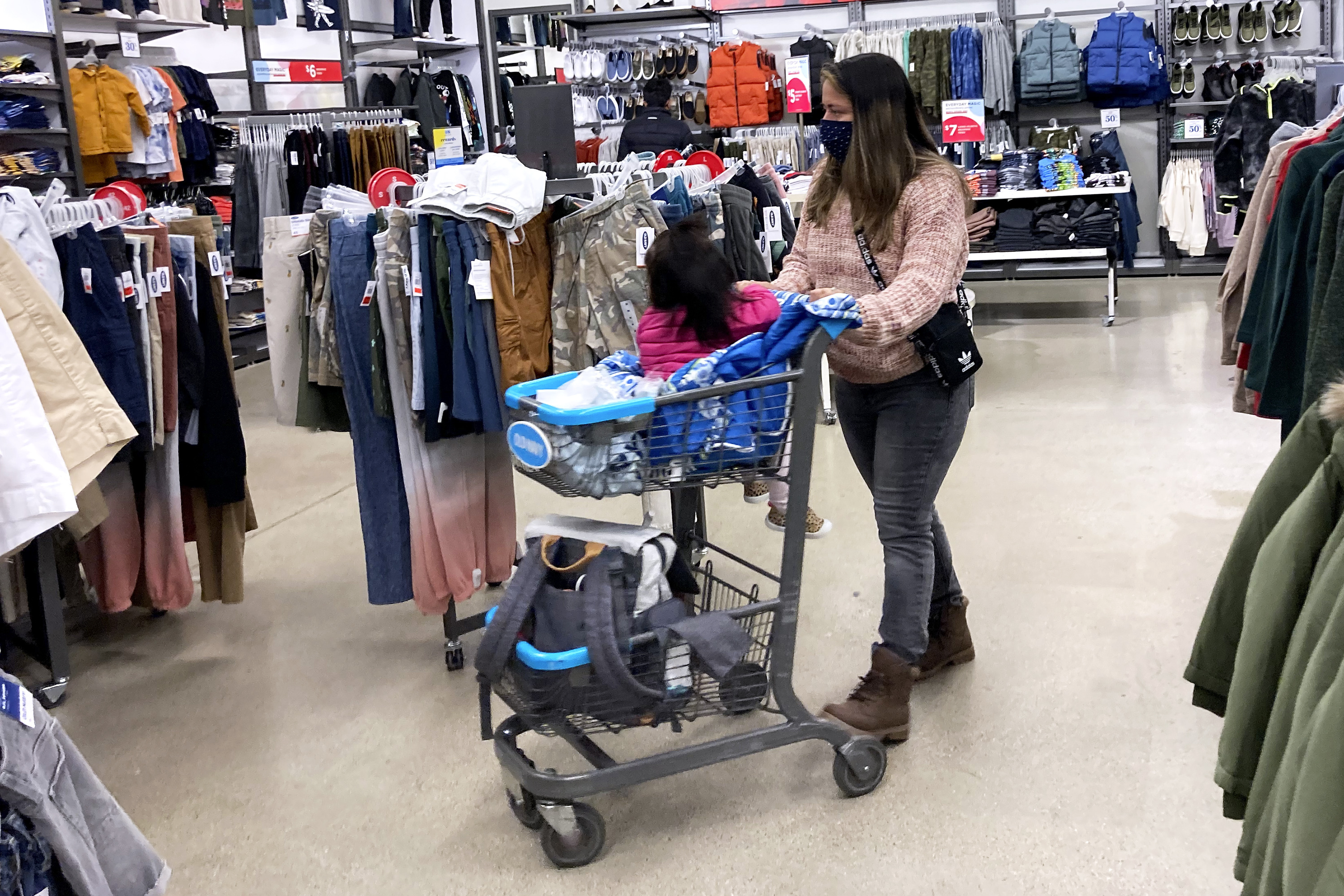 Consumers shop at a retail store in Vernon Hills, Ill., Saturday, Nov. 13, 2021. Retail sales took an unexpected dip in December 2021 in what could be a signal that the increasing weight of persistently rising inflation is prompting a pullback in consumer spending. 
