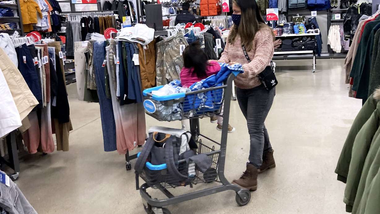Consumers shop at a retail store in Vernon Hills, Ill., Saturday, Nov. 13, 2021. Retail sales took an unexpected dip in December 2021 in what could be a signal that the increasing weight of persistently rising inflation is prompting a pullback in consumer spending.